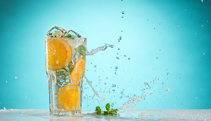 Image showing The rose exotic cocktail and fruit on blue