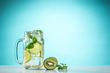 Image showing The rose exotic cocktail and fruit on blue