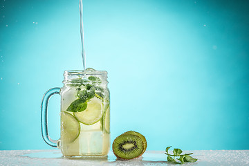 Image showing The rose exotic cocktail and fruit on blue