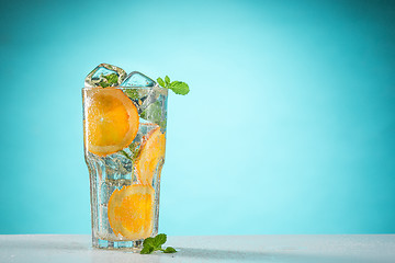 Image showing The rose exotic cocktail and fruit on blue