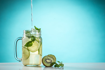 Image showing The rose exotic cocktail and fruit on blue