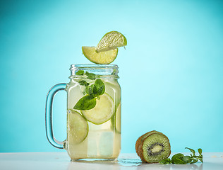 Image showing The rose exotic cocktail and fruit on blue