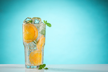 Image showing The rose exotic cocktail and fruit on blue