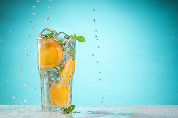 Image showing The rose exotic cocktail and fruit on blue