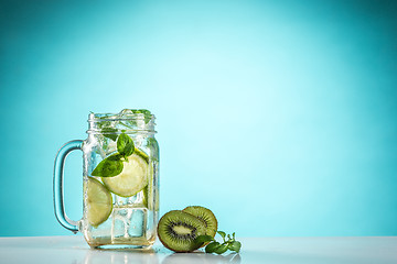 Image showing The rose exotic cocktail and fruit on blue