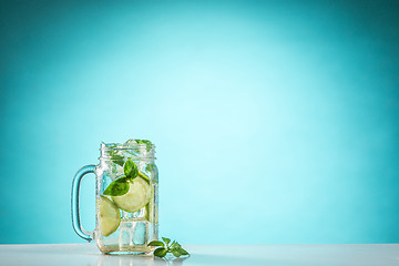 Image showing The rose exotic cocktail and fruit on blue