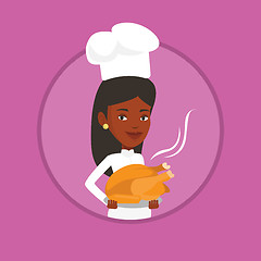 Image showing Chef cook holding roasted chicken.