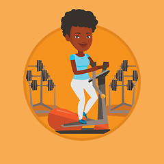 Image showing Woman exercising on elliptical trainer.