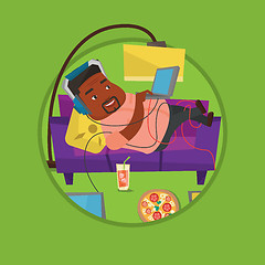 Image showing Man lying on sofa with many gadgets.