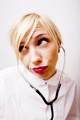 Image showing young pretty woman doctor with stethoscope emotional posing, pointing in camers, lifestyle people concept 