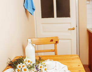 Image showing Simply stylish wooden kitchen with bottle of milk and glass on t