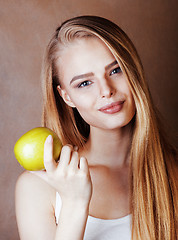 Image showing young pretty blond woman with green apple happy cheerful smiling