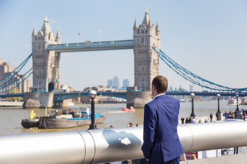 Image showing British businessman talking on mobile phone outdoor in London city, UK.