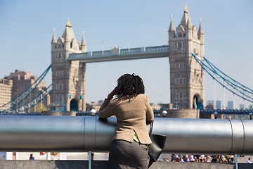 Image showing British businesswoman talking on mobile phone outdoor in London city, UK.