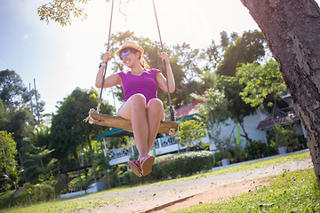 Image showing Brunette on swing at beach