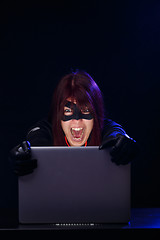 Image showing Screaming woman hacker at night