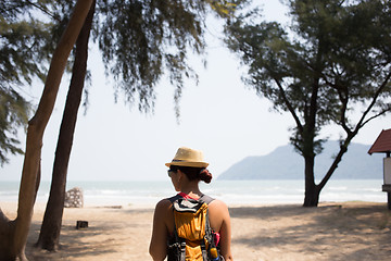 Image showing Brunette in hat stands back