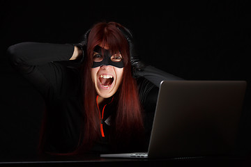 Image showing Brunette hacker in black mask