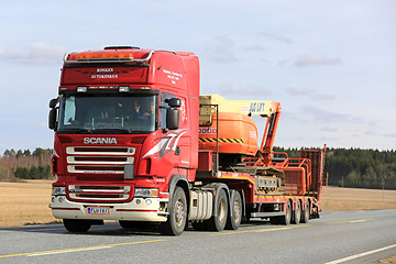 Image showing Red Scania Semi Transports Boom Lift along Highway 