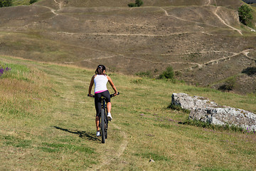 Image showing Mountain biking happy sportive girl relax in meadows sunny countryside