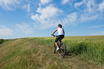 Image showing Mountain biking happy sportive girl relax in meadows sunny countryside