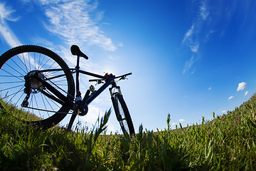 Image showing bicycle in meadow during sunset