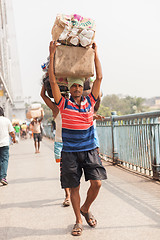 Image showing Man carrying load on the Howrah Bridge