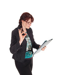 Image showing Businesswoman standing with clipboard.