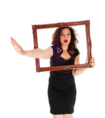 Image showing Woman looking trough picture frame.