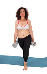 Image showing Woman lifting two dumbbells.