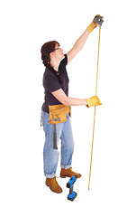 Image showing A handy woman measuring for work.