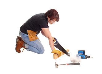 Image showing Woman working with her saw.