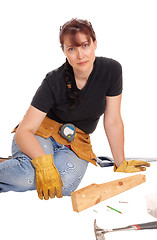 Image showing Woman sitting and working with tools.