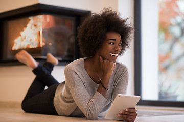 Image showing black women using tablet computer on the floor