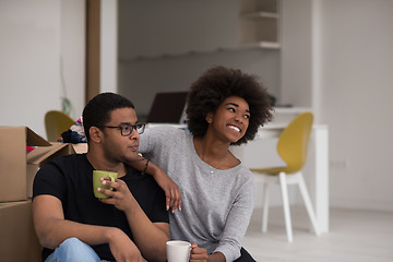 Image showing African American couple relaxing in new house