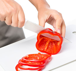 Image showing Cook is chopping bell pepper