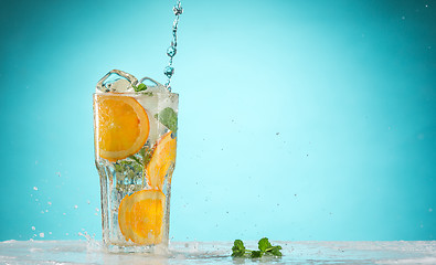 Image showing The rose exotic cocktail and fruit on blue