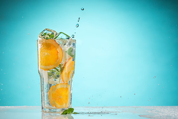 Image showing The rose exotic cocktail and fruit on blue