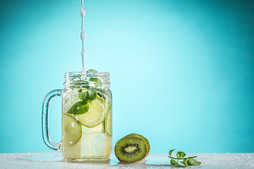 Image showing The rose exotic cocktail and fruit on blue