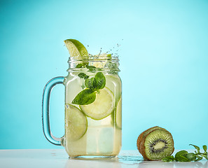 Image showing The rose exotic cocktail and fruit on blue