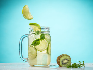 Image showing The rose exotic cocktail and fruit on blue