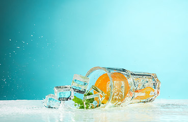 Image showing The rose exotic cocktail and fruit on blue