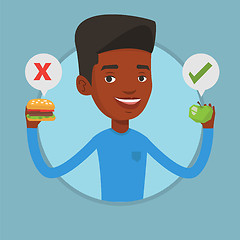 Image showing Man choosing between hamburger and cupcake.