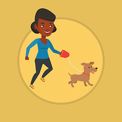 Image showing Young woman walking with her dog.