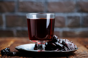 Image showing drink and dry plums