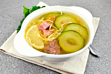 Image showing Soup with zucchini and noodles on stone table