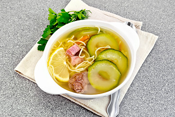 Image showing Soup with zucchini and noodles on granite table