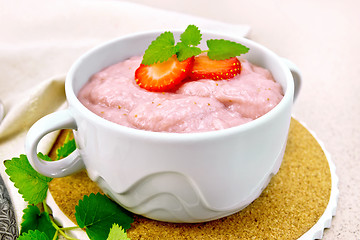 Image showing Soup strawberry in bowl with mint on stone table