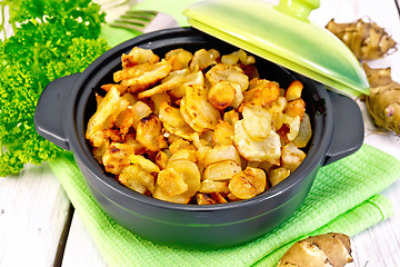 Image showing Jerusalem artichoke roasted in brazier on light board