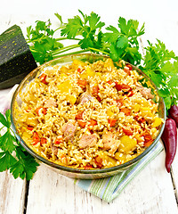 Image showing Rice with chicken and zucchini in pan on light board